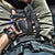 POV image looking into a male's lap full of tactical gear including a gun, knife, multi-tool, BAMFF 10 tactical flashlight, and more