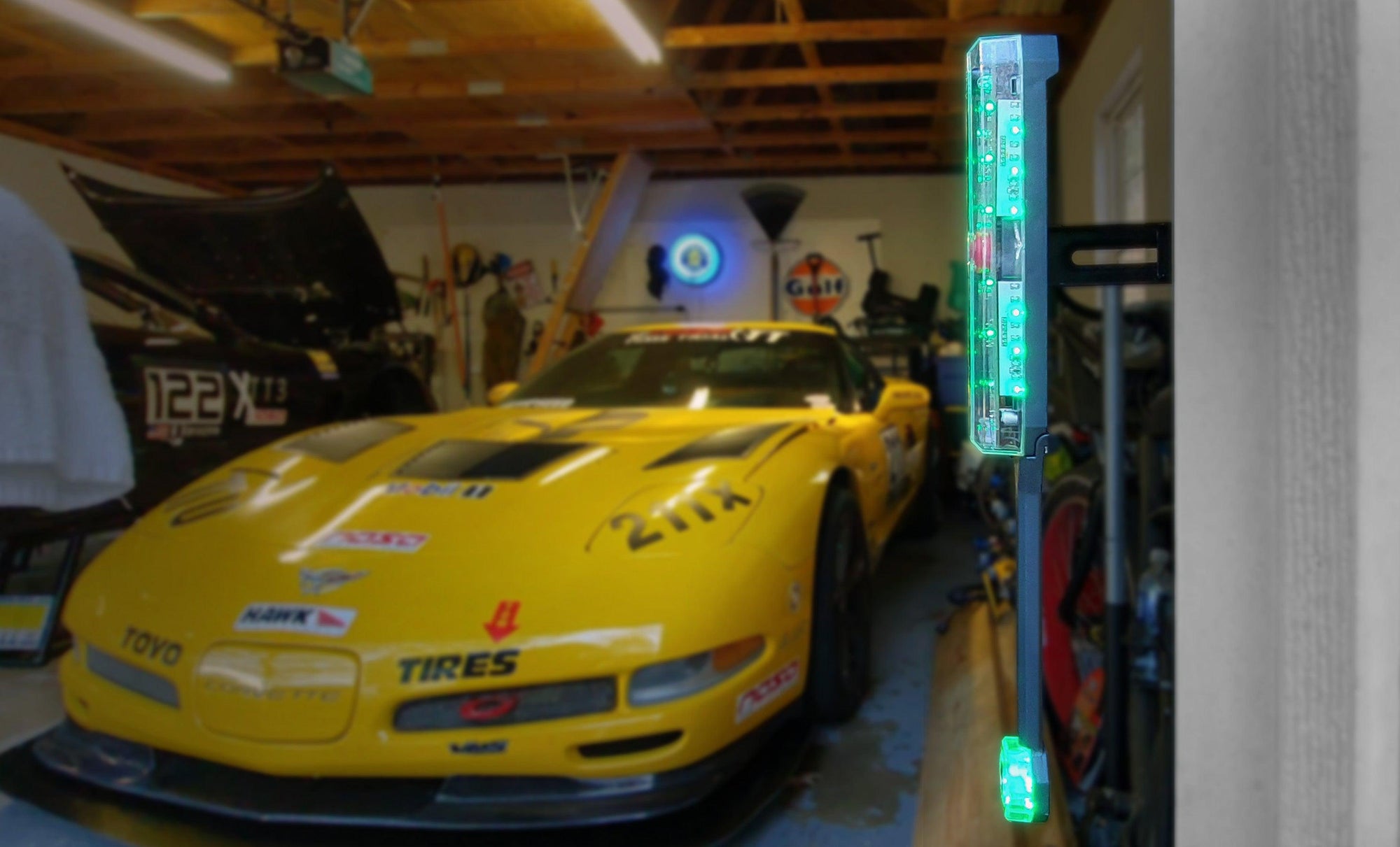 STKR Side Parking Sensor in the Foreground. Corvette in a garage setting in the background.