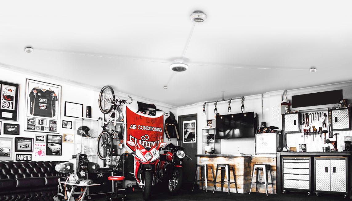 Garage decorated with racing stuff with a small bar and some tools. All illuminated by an MPI from STKR Concepts