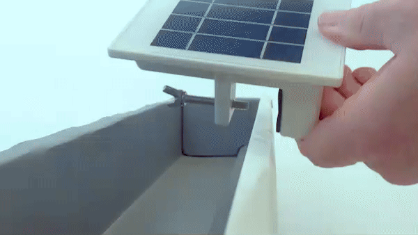 quick video of just hands reaching into frame demonstrating how to attach an EZ Security Solar Light onto a piece of gutter.
