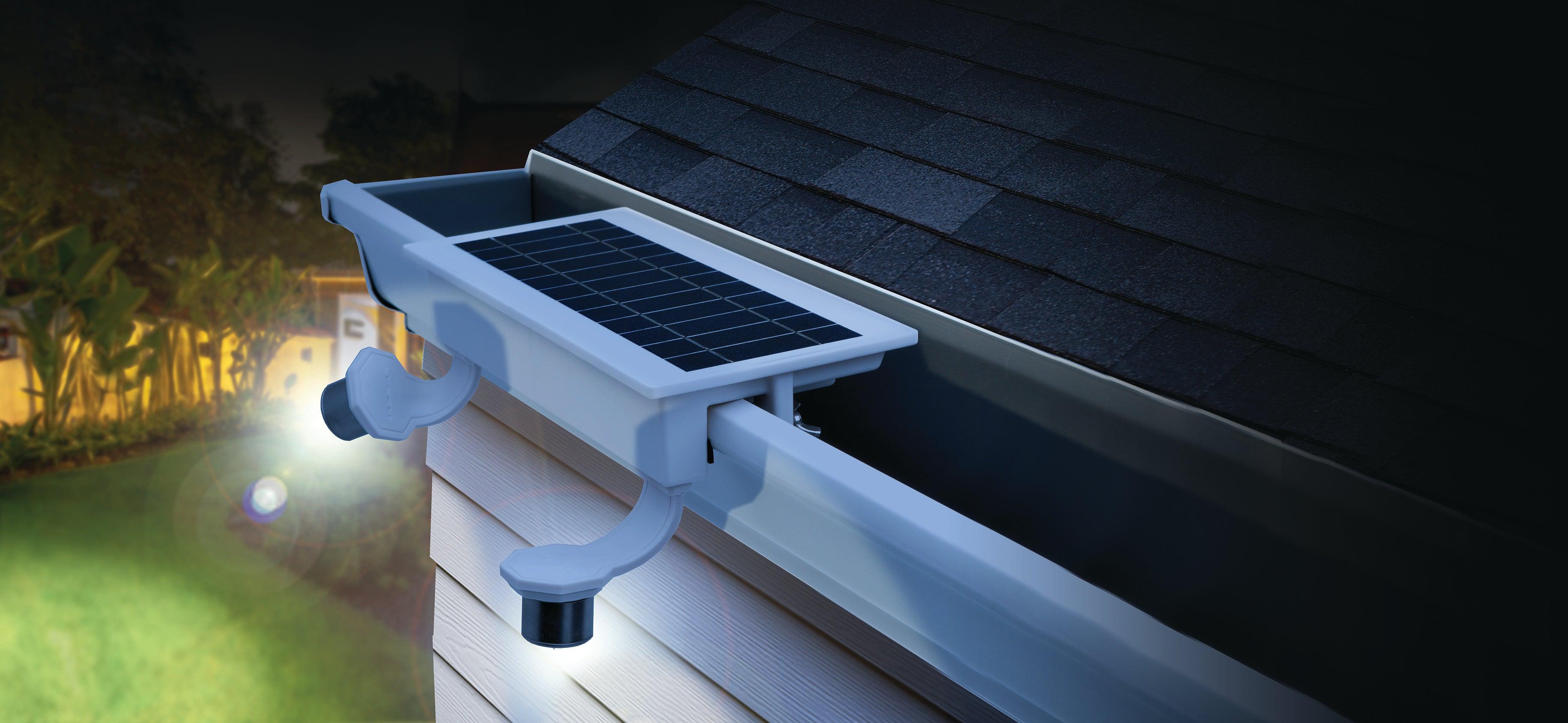 EZ Home Security FLEXIT SpotLight mounted on a white gutter shown from above with a lit up yard below