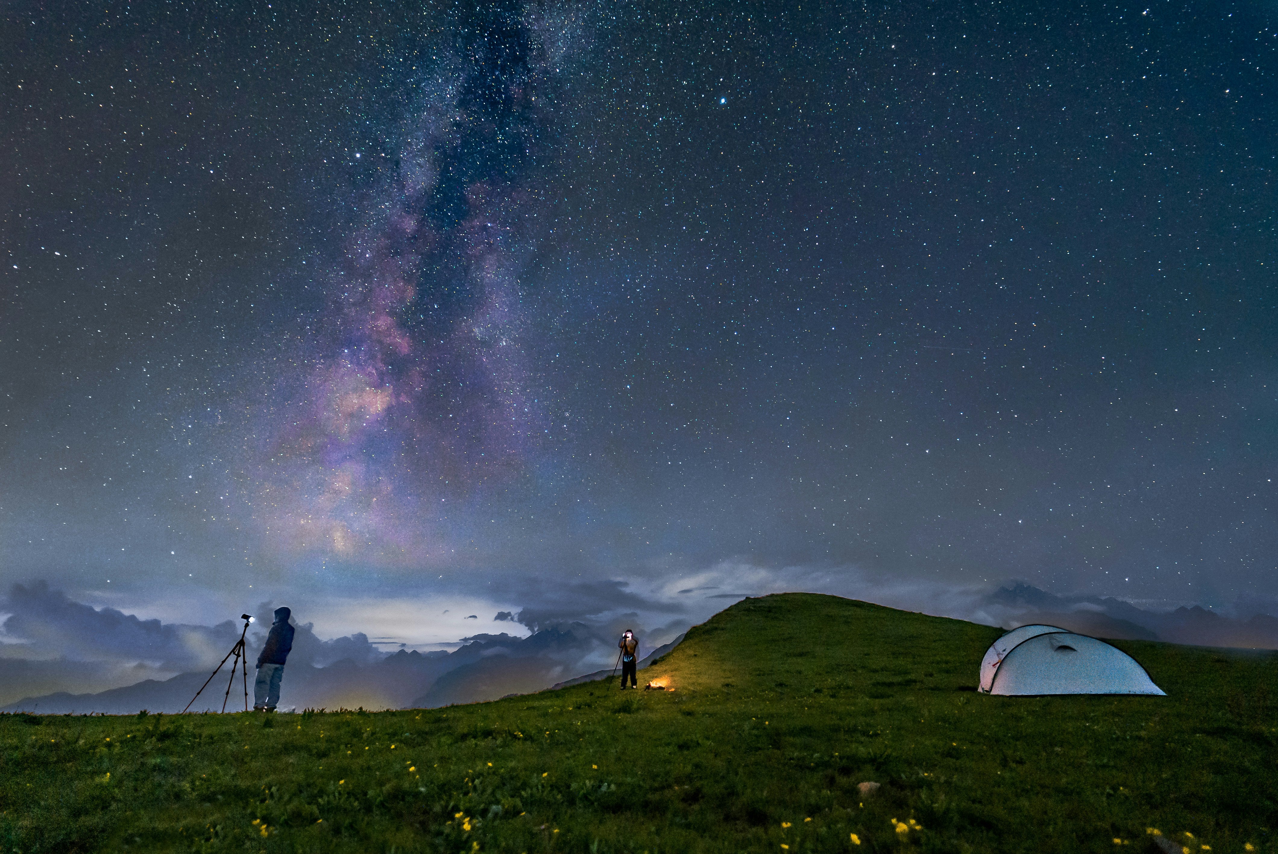 camping scene with the galaxy night sky in the background