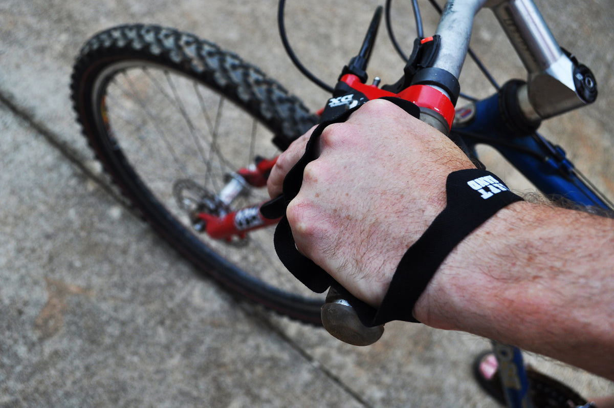 Palm Protector worn on a hand gripping a mountain bike handlebar