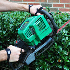 Palm Protectors worn on both hands running a gas hedge trimmer