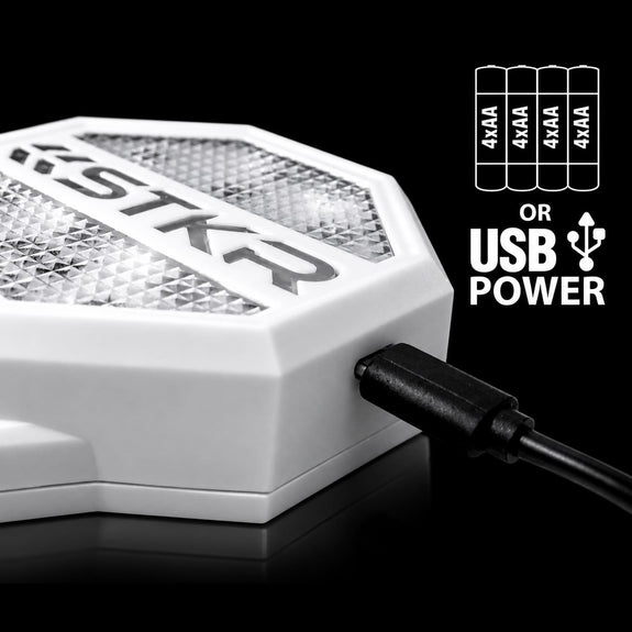 White STKR Garage Parking Sensor LT powered by four AA batteries or USB, shown on black